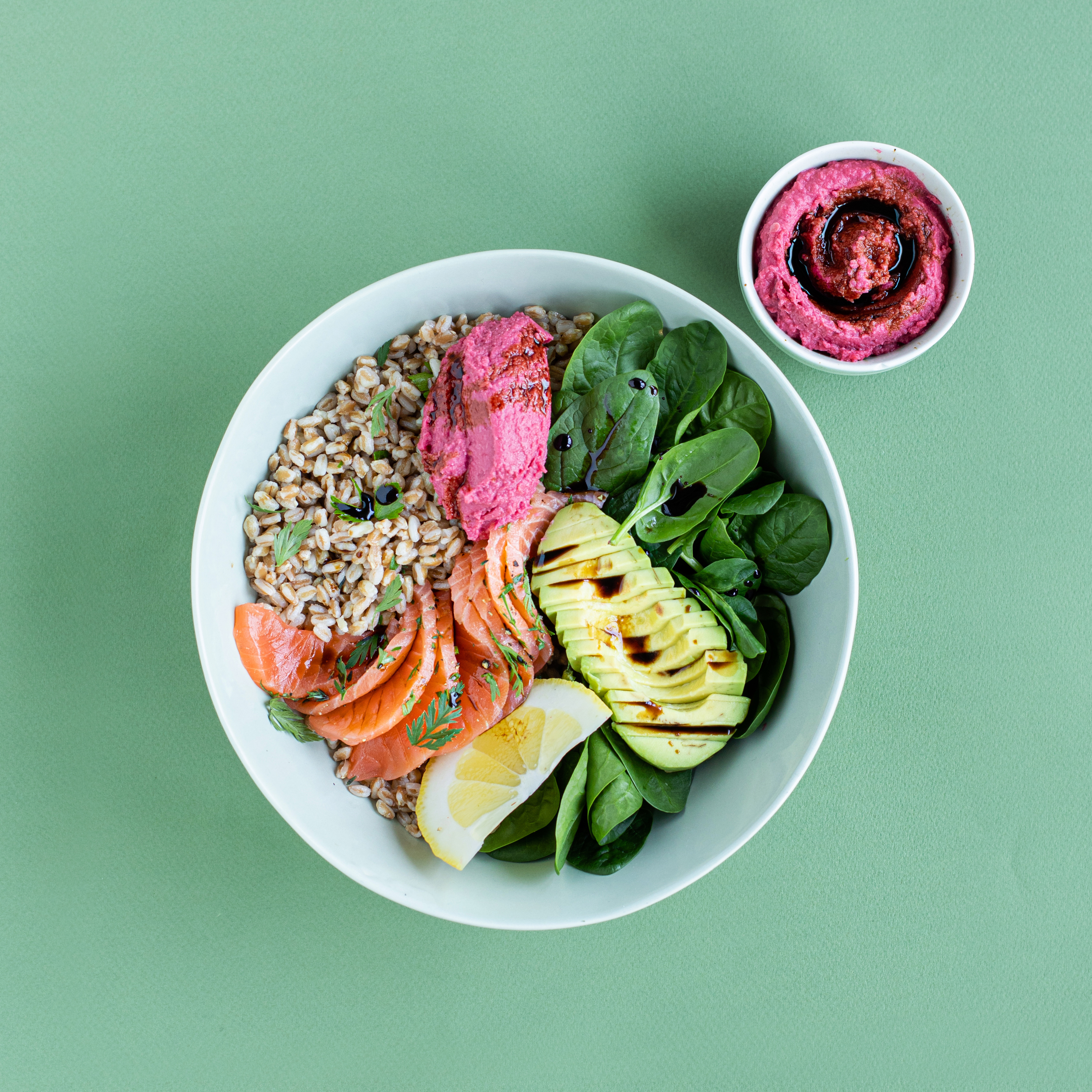 Bowl of spelt, marinated salmon, beetroot hummus and Balsamic Vinegar of Modena PGI