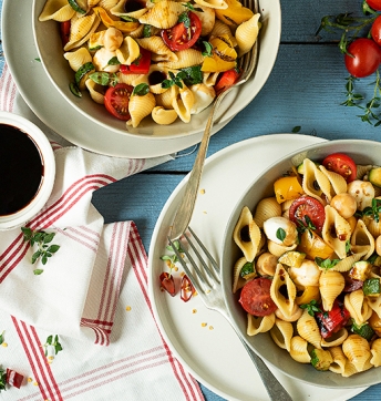 Pasta salad with vegetables and small mozzarella balls