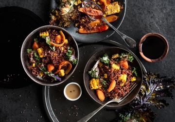 Roasted red rice with carrots, corn and kale