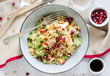 Cous cous salad with raw vegetables, pomegranate and walnuts