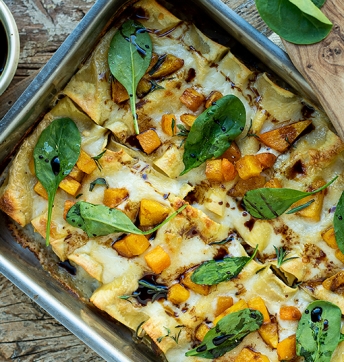 Cannelloni stuffed with ricotta cheese, spinach and mushrooms with diced pumpkin